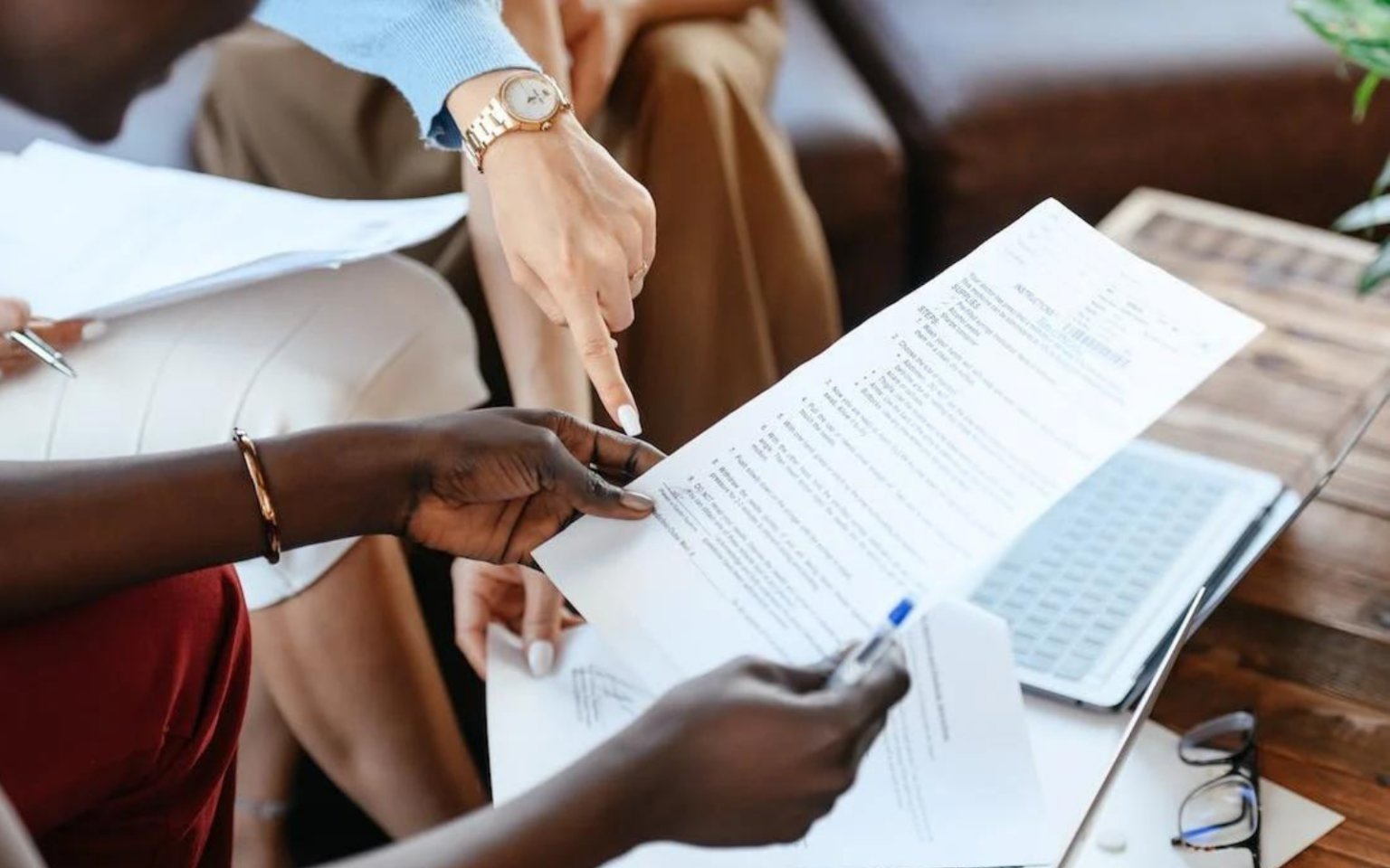 Two hiring managers looking at a CV trying to spot the signs of CV fraud