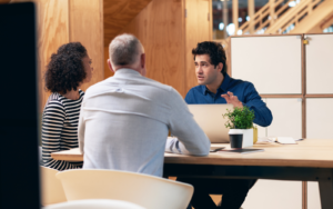 man discussing with managers about skills based hiring