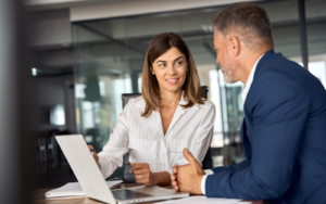 two business professionals discussing how to hire for their tech workforce