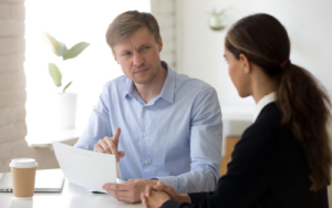 man looking suspicious at candidate because he suspects an ai-generated cv