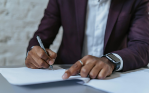 man ready to sign contracts after understanding contractor compliance