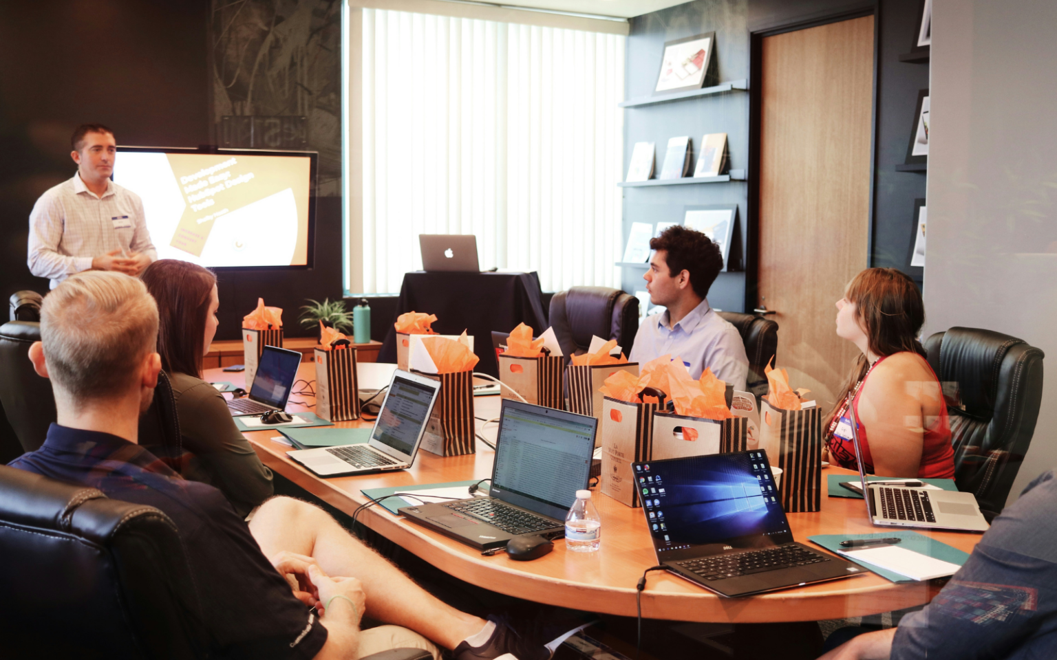 A group of professionals sitting around a table discussing HR buzzwords